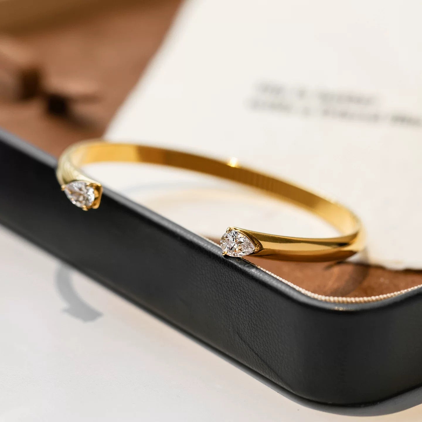 Elegant Gold Open Cuff Bangle with Pear-Cut Crystal Ends