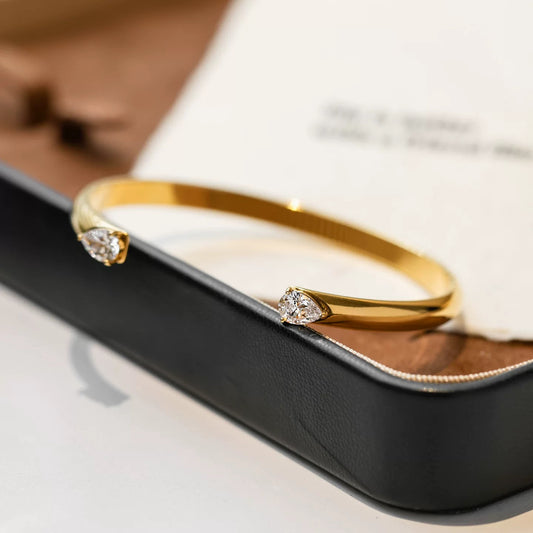 Elegant Gold Open Cuff Bangle with Pear-Cut Crystal Ends